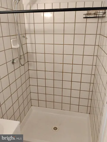 a bathroom with a granite countertop toilet a sink and bathtub