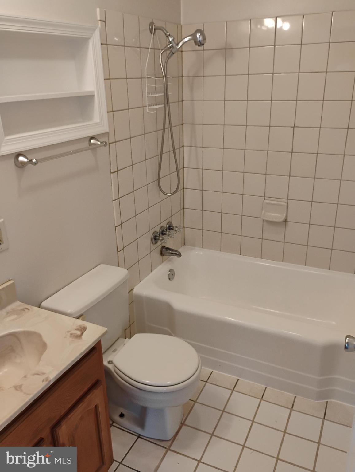 933 Andrews Road Glen Burnie, MD 21060 - Photo 17 of 22 a bathroom with a granite countertop toilet a sink and bathtub