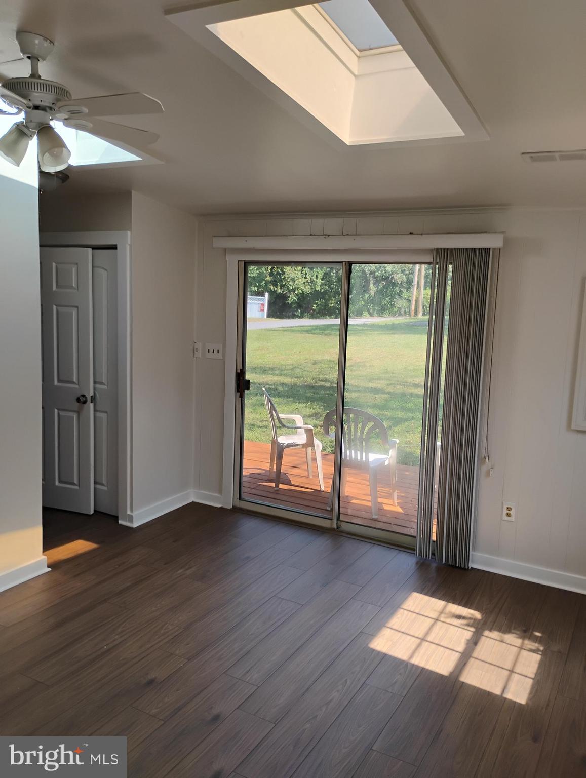 933 Andrews Road Glen Burnie, MD 21060 - Photo 19 of 22 an empty room with wooden floor and windows