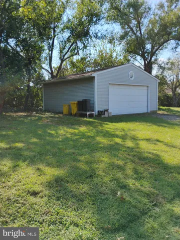 a view of a backyard with large trees