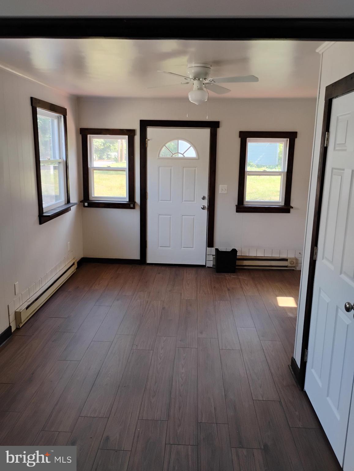 933 Andrews Road Glen Burnie, MD 21060 - Photo 6 of 22 a view of an entryway with wooden floor and door