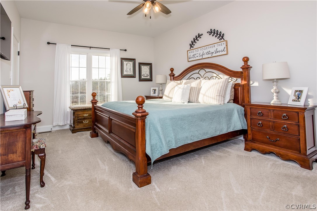 13790 Glebe Road Dewitt, VA 23840 - Photo 12 of 39 a bedroom with a bed and a chandelier