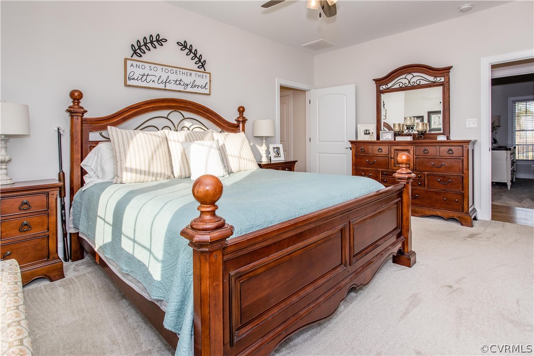 13790 Glebe Road Dewitt, VA 23840 - Photo 13 of 39 a bedroom with a bed and a chandelier