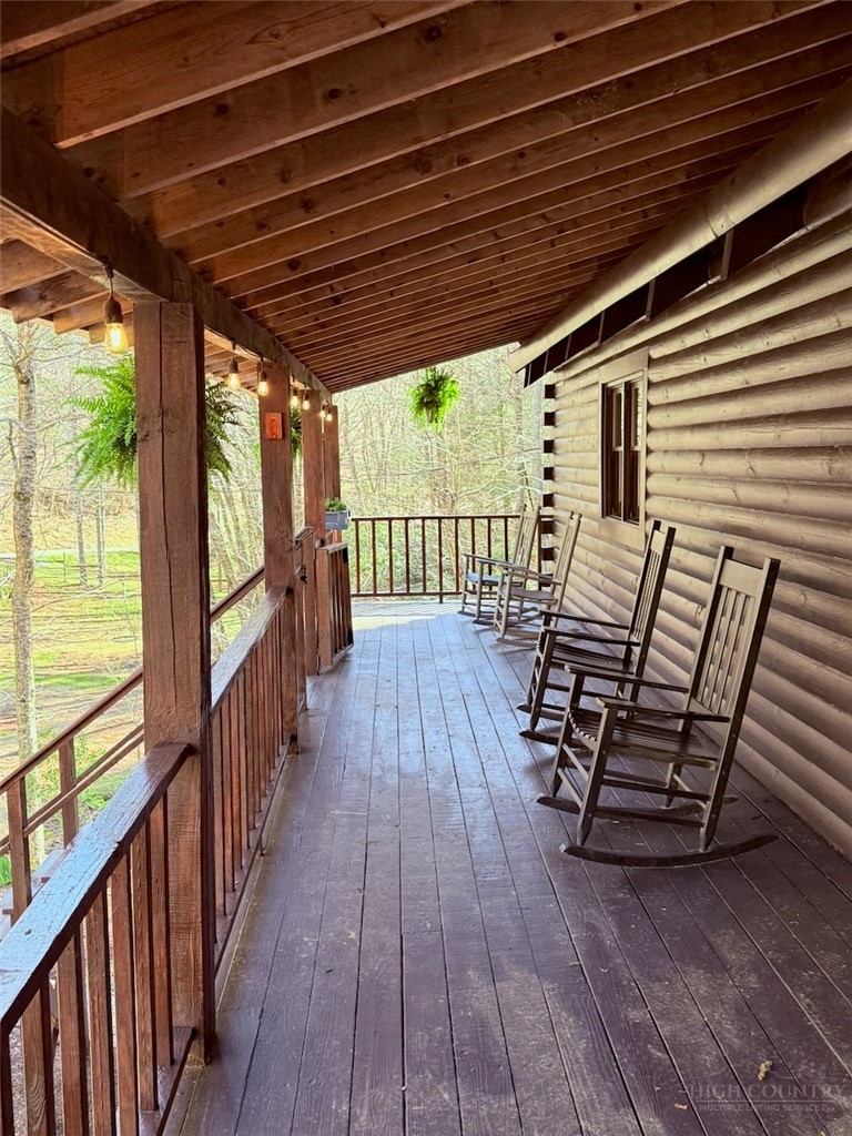 2291 Pine Swamp Road Fleetwood, NC 28626 - Photo 18 of 37 a view of a patio with wooden floor with outdoor seating