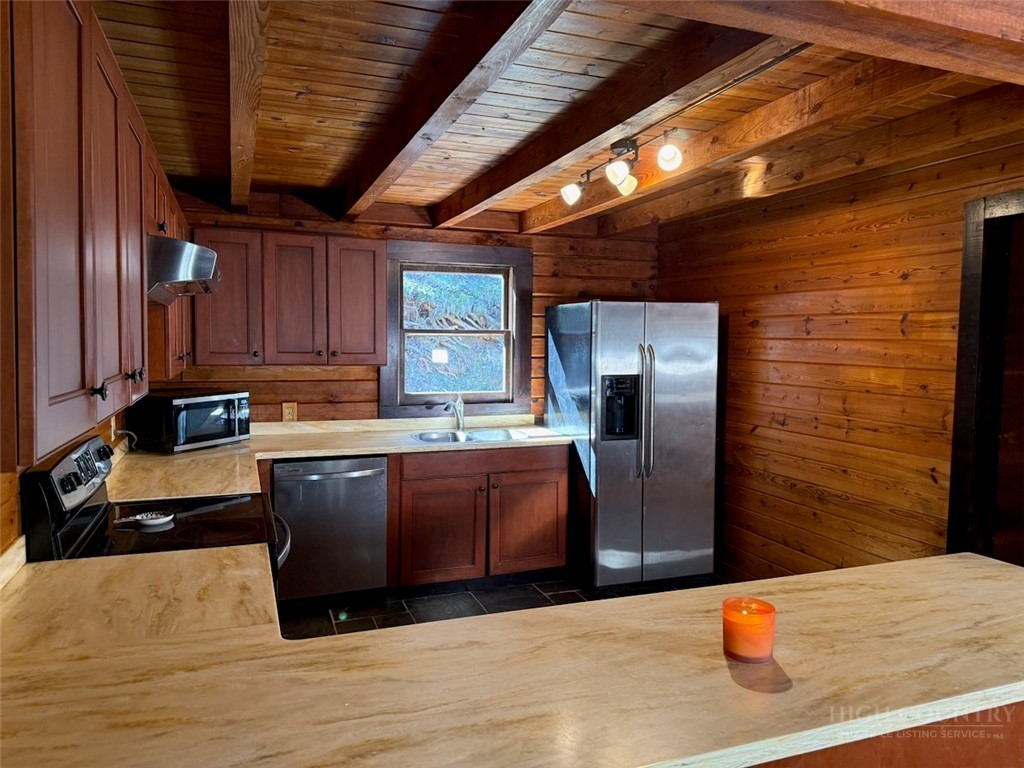 2291 Pine Swamp Road Fleetwood, NC 28626 - Photo 23 of 37 a kitchen with stainless steel appliances granite countertop a refrigerator a stove and a wooden cabinets