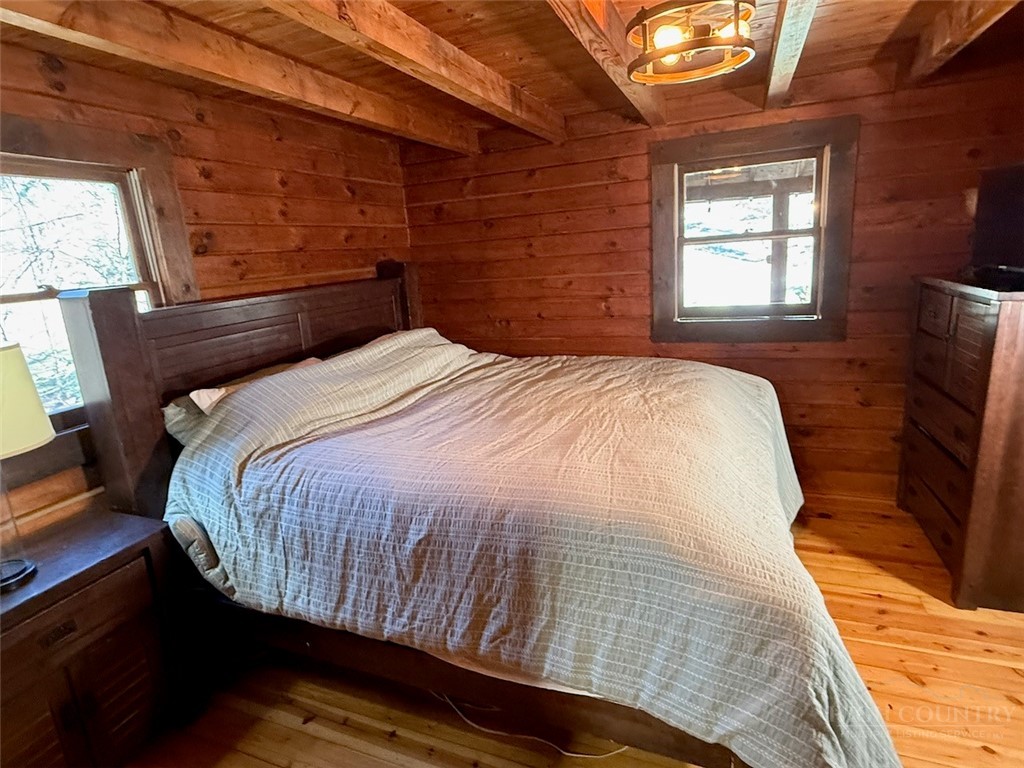 2291 Pine Swamp Road Fleetwood, NC 28626 - Photo 26 of 37 a bed sitting in a bedroom next to a window