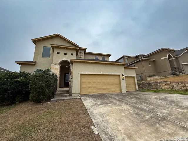 a front view of a house with a yard and garage