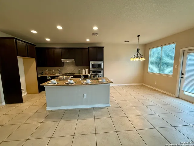 a view of a livingroom with a furniture and chandelier fan