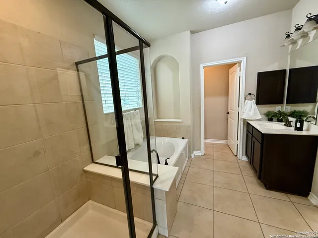 a bathroom with a sink a mirror and a shower