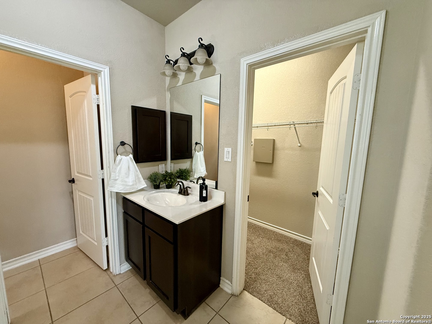 2930 Elm Tree Park San Antonio, TX 78259 - Photo 18 of 44 a bathroom with a sink a mirror and a shower