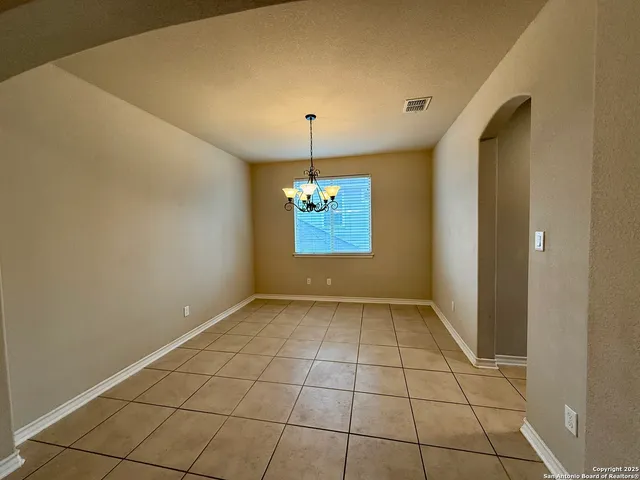 a view of empty room with window and fireplace