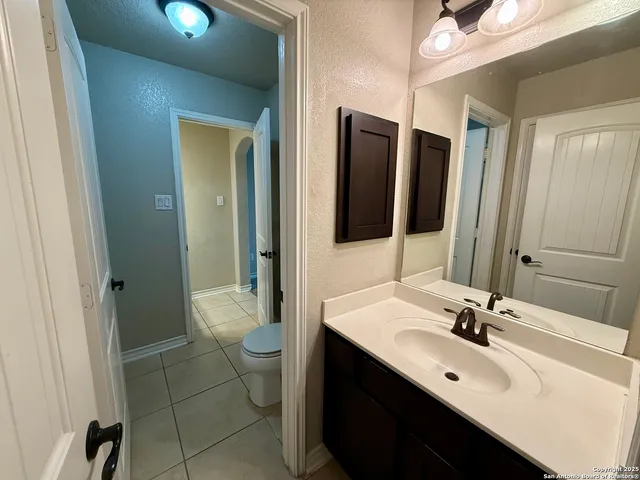 a bathroom with a sink vanity and a mirror