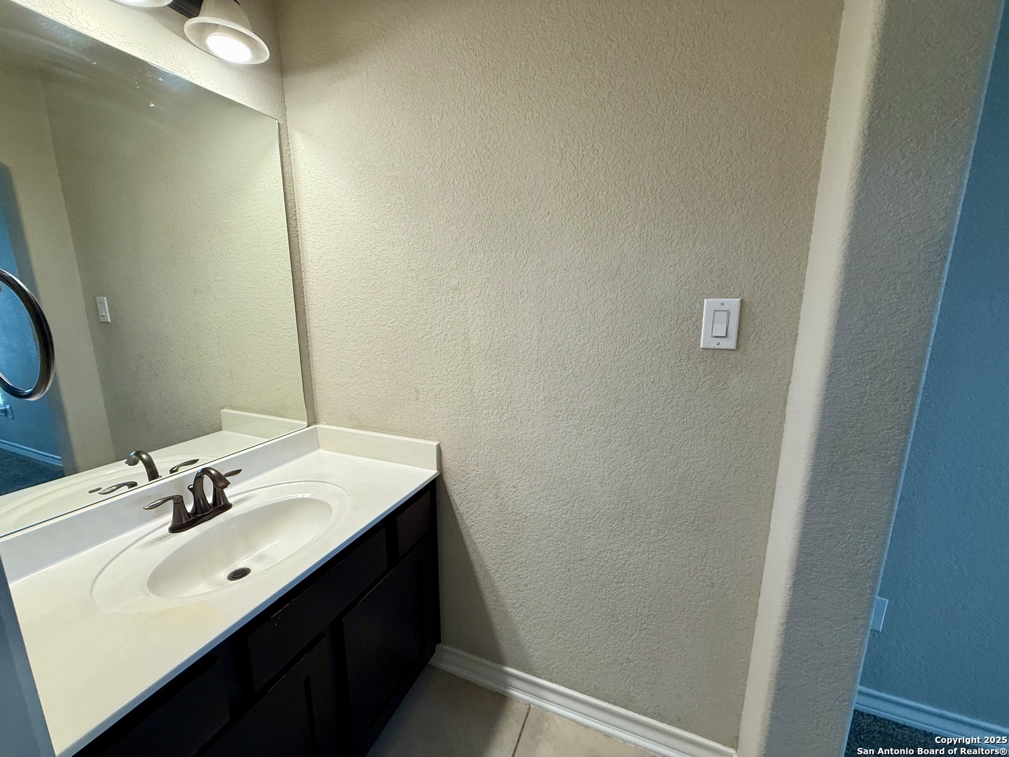 2930 Elm Tree Park San Antonio, TX 78259 - Photo 32 of 44 a bathroom with a sink vanity and a mirror
