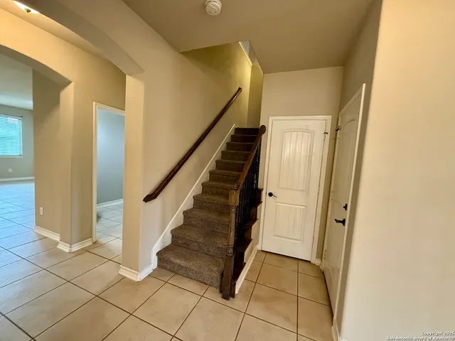a view of entryway with wooden floor and stairs