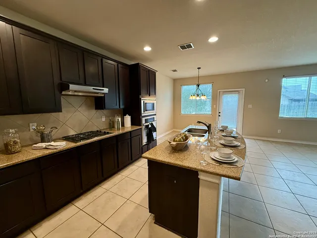 a view of a kitchen with furniture and a fireplace