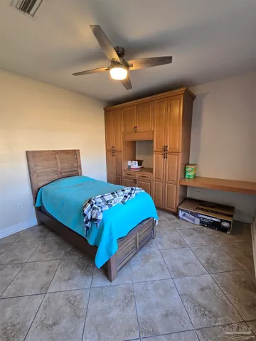 a bedroom with a bed and a dresser