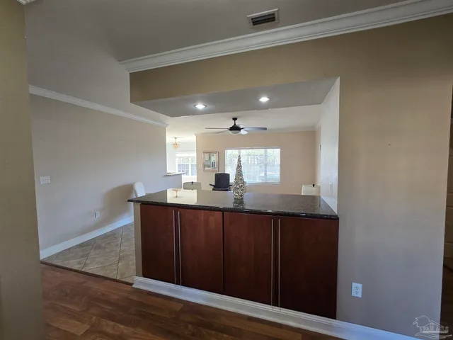 a kitchen with granite countertop wooden cabinets and sink