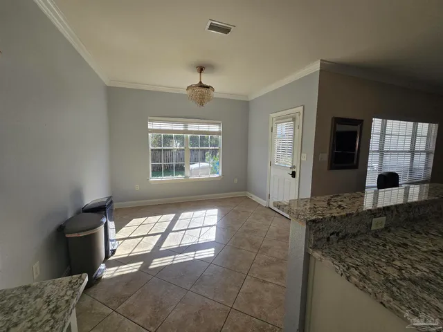 a spacious bathroom with a granite countertop sink and a window