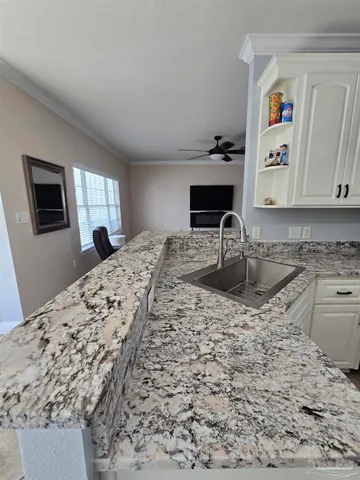 a kitchen with sink refrigerator and window