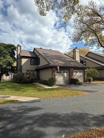 a view of a house with a big yard and large trees