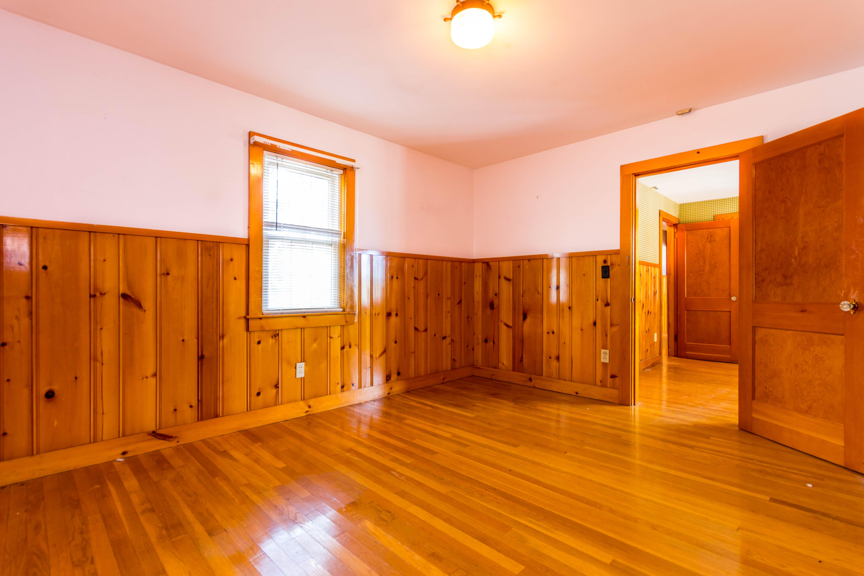 655 County Road Rochester, MA 02576 - Photo 13 of 26 an empty room with wooden floor and a bathroom