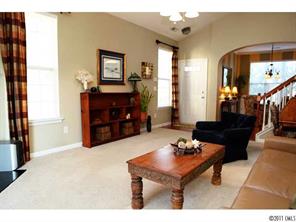 215 Dawn Mist Lane, Unit 215 Fort Mill, SC 29708 - Photo 5 of 16 a living room with furniture and a table