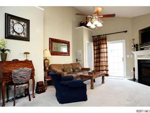 215 Dawn Mist Lane, Unit 215 Fort Mill, SC 29708 - Photo 6 of 16 a living room with furniture a chandelier and a flat screen tv