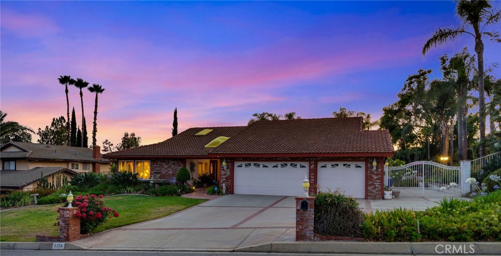 a front view of a house with a garden and a yard