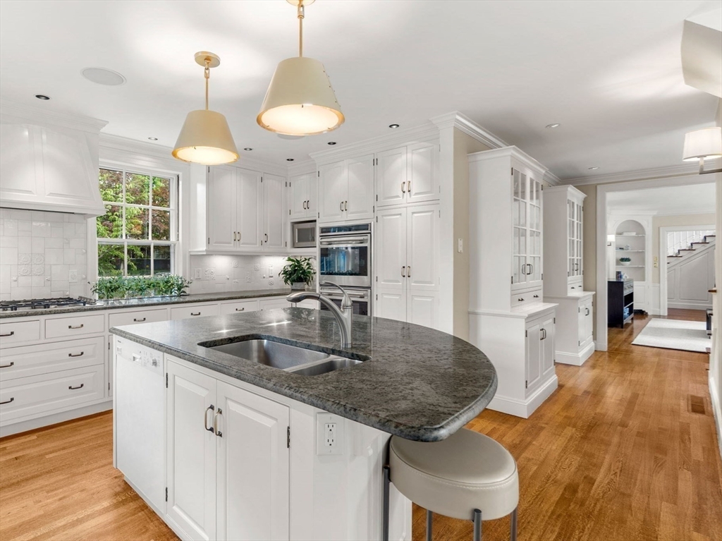 20 Foxcroft Road Winchester, MA 01890 - Photo 11 of 42 a kitchen with stainless steel appliances granite countertop a sink a stove refrigerator and cabinets