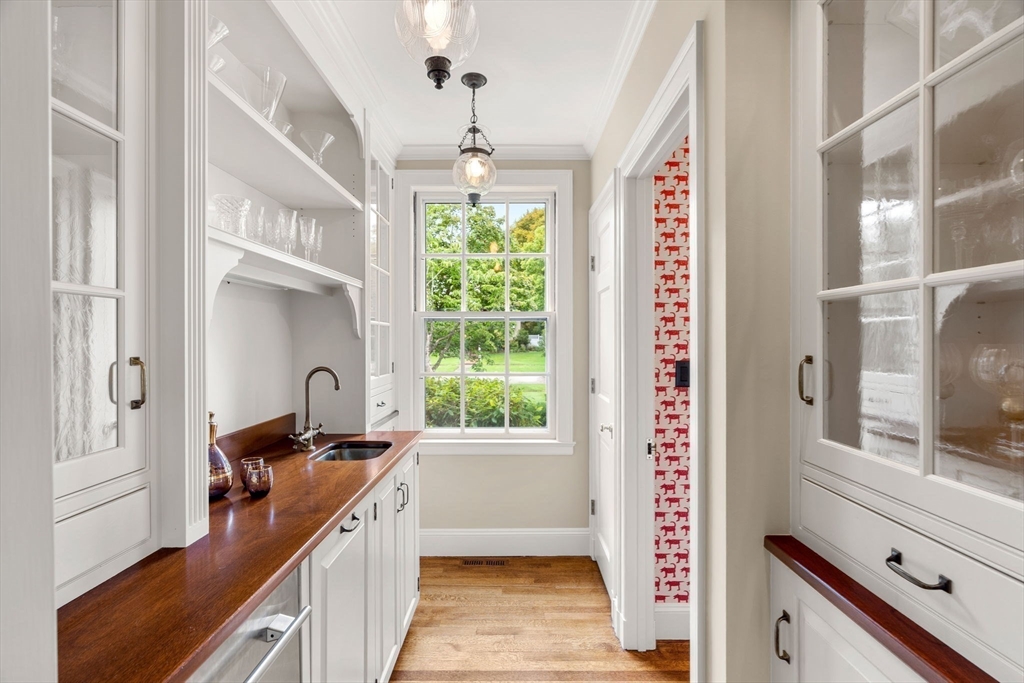 20 Foxcroft Road Winchester, MA 01890 - Photo 13 of 42 a hallway with a large window and chandelier