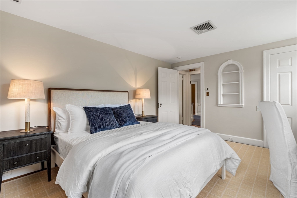 20 Foxcroft Road Winchester, MA 01890 - Photo 29 of 42 a bedroom with a bed and a lamp