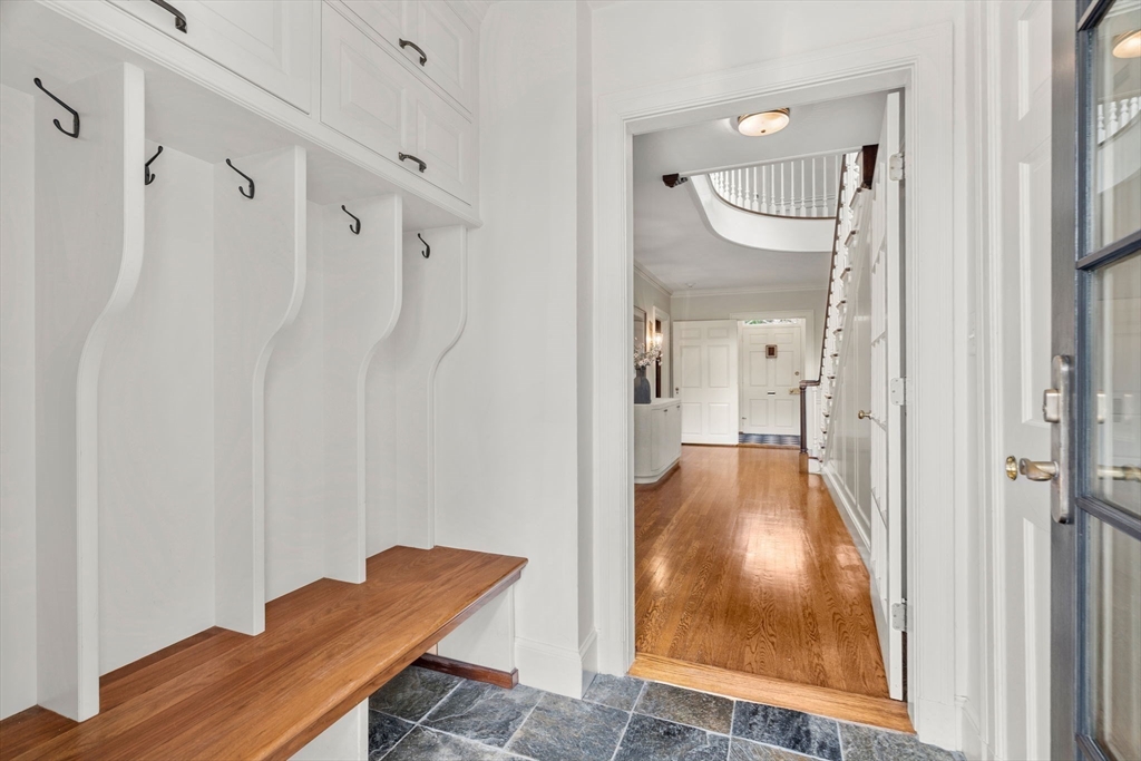 20 Foxcroft Road Winchester, MA 01890 - Photo 33 of 42 a view of a hallway with wooden floor and glass door