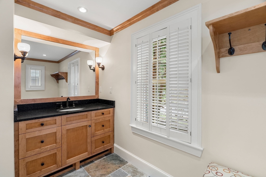 20 Foxcroft Road Winchester, MA 01890 - Photo 36 of 42 a bathroom with a granite countertop sink a mirror and a