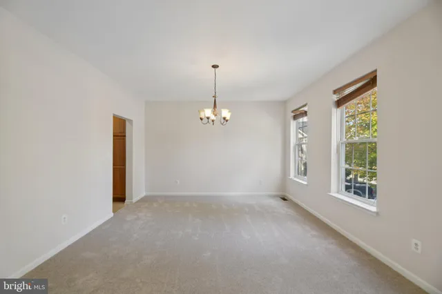 an empty room with windows and entrance