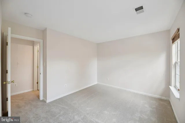 a view of an empty room and a window