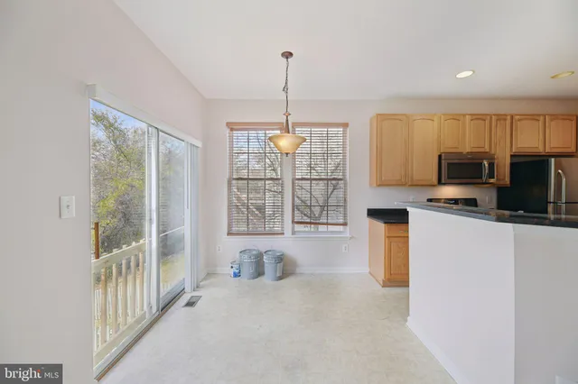 a kitchen with microwave and window
