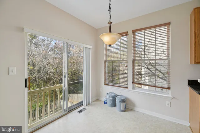 a very nice looking room with a large window and a chandelier