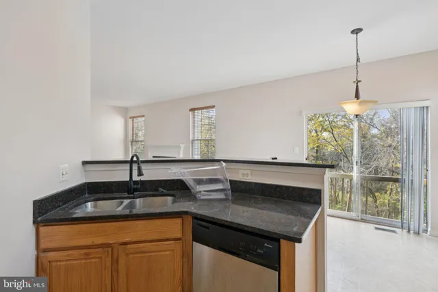 a kitchen with a sink a counter space and cabinets