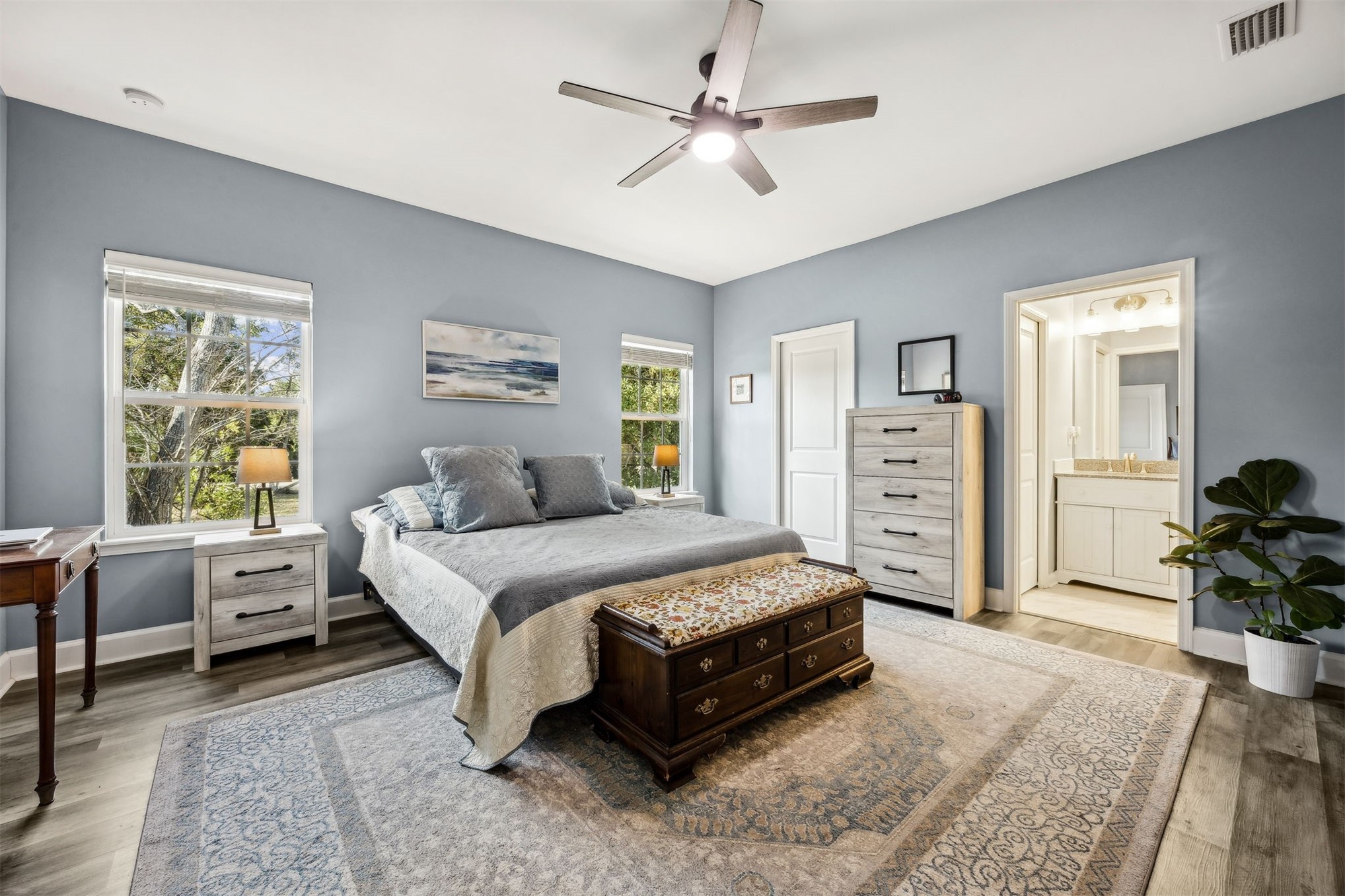 307 Elm Street Fernandina Beach, FL 32034 - Photo 15 of 35 a spacious bedroom with a bed a dresser and a chandelier