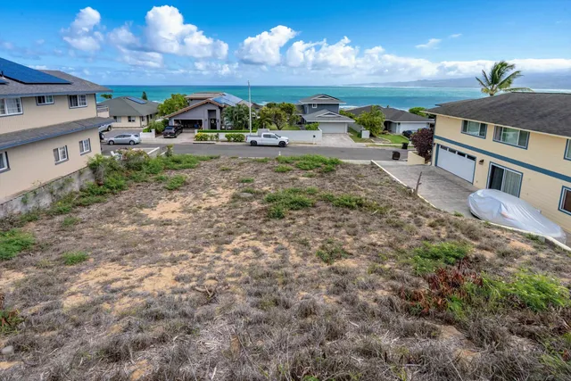a view of a house with a yard and sitting area