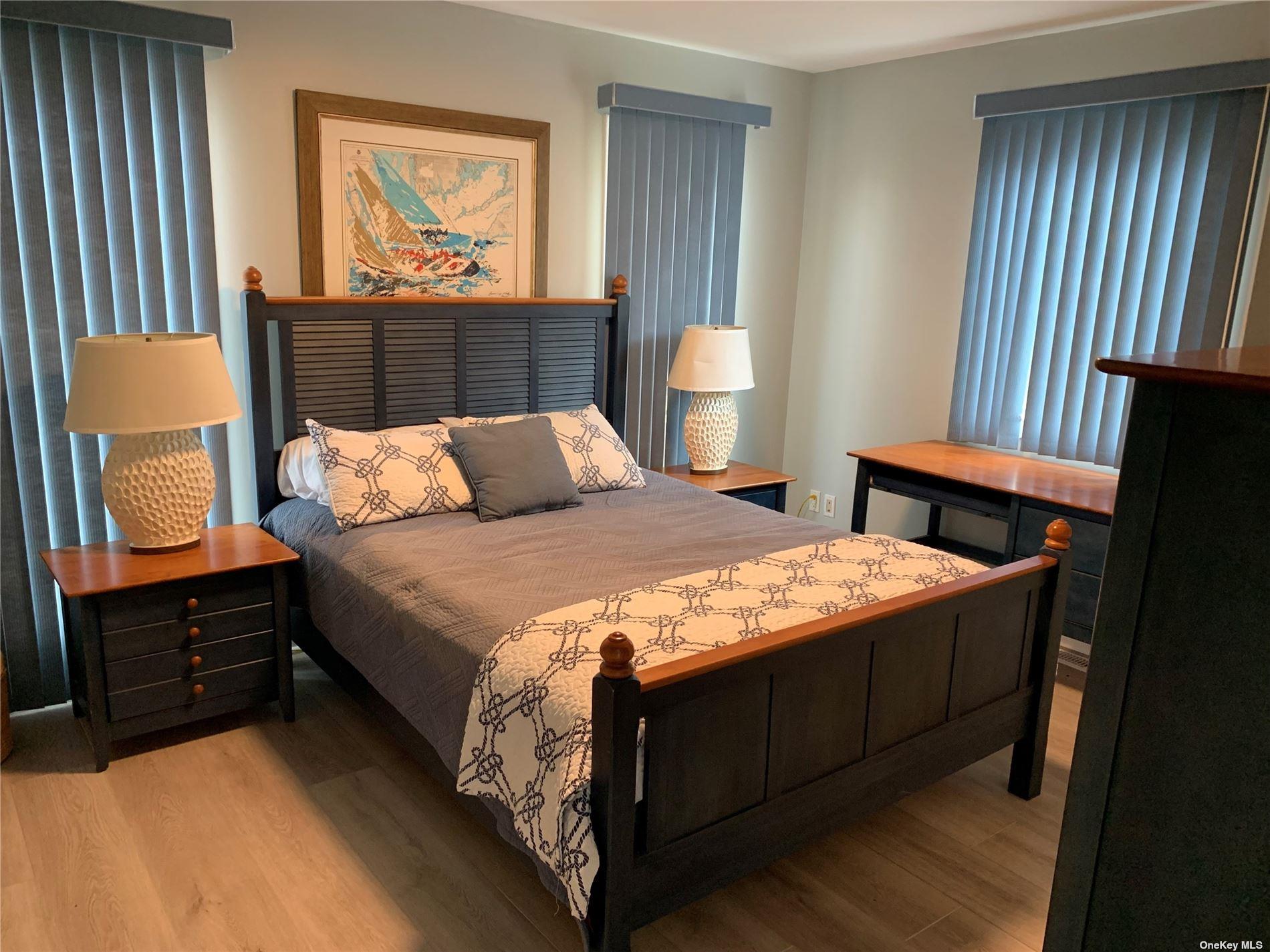 187 Cottage Walk Ocean Beach, NY 11770 - Photo 5 of 9 a bedroom with a bed and a painting on the wall