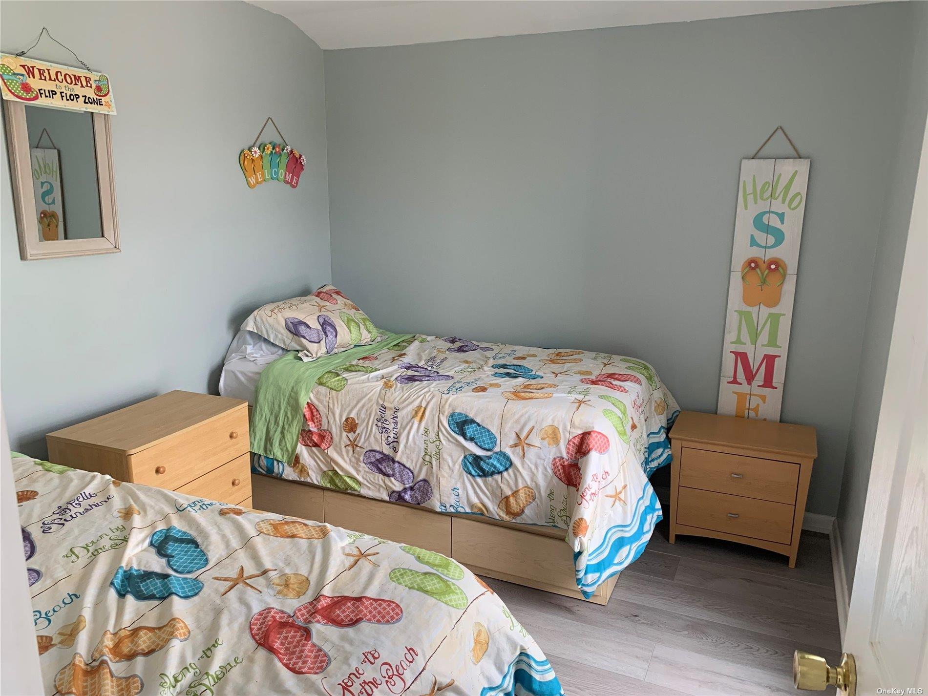 187 Cottage Walk Ocean Beach, NY 11770 - Photo 8 of 9 a bedroom with a bed and window