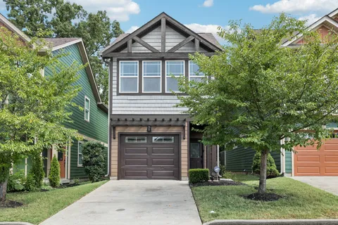 a front view of a house with a garden