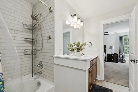 a bathroom with a sink a mirror and a bathtub