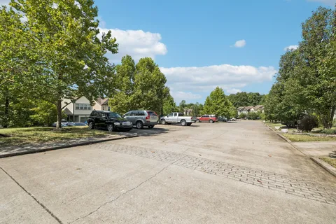 a view of road with card parked on side and road