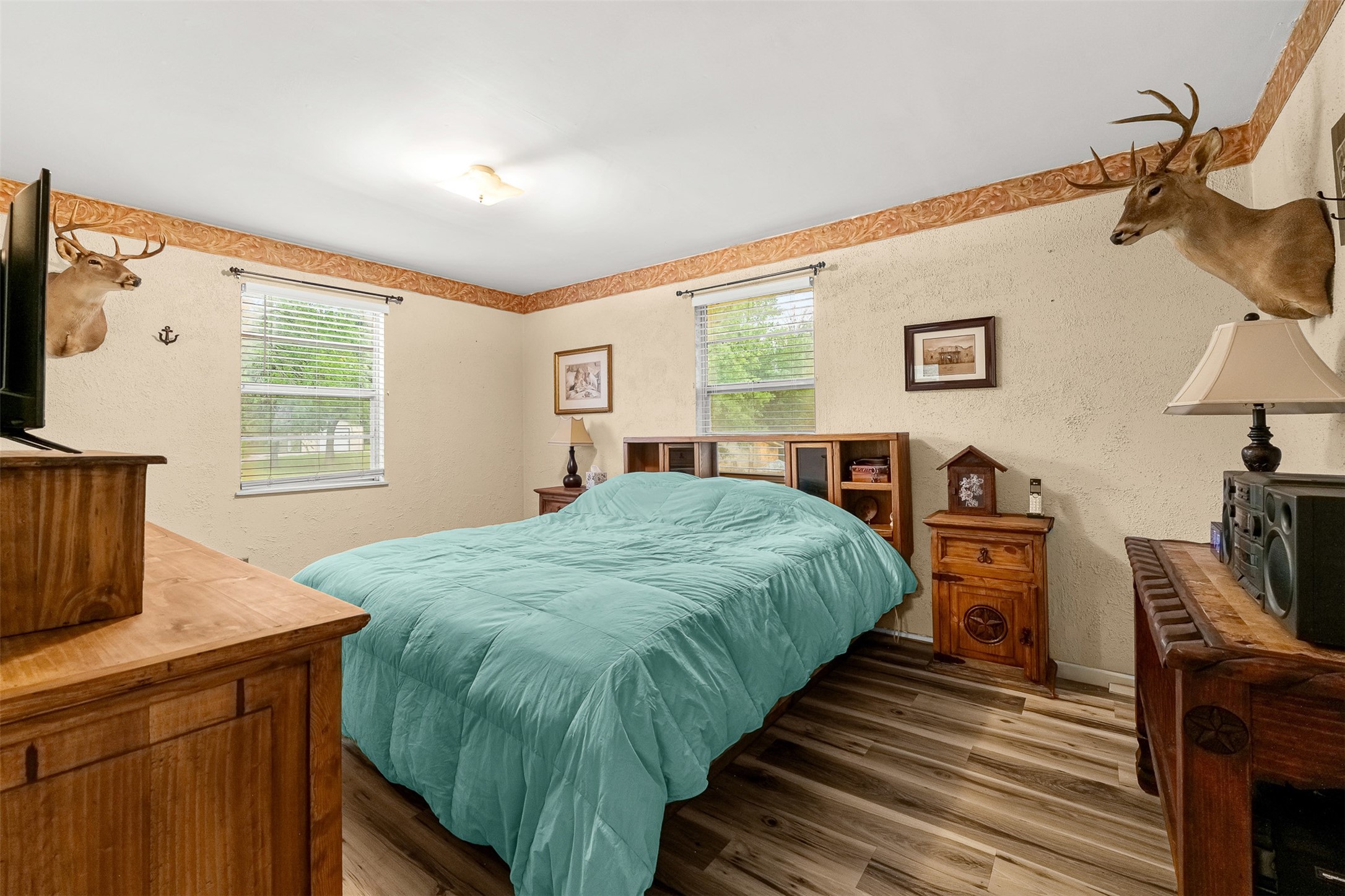 439 Lakeview Harbor Onalaska, TX 77360 - Photo 16 of 43 a bed sitting in a bedroom next to a window with a flat screen tv and dresser