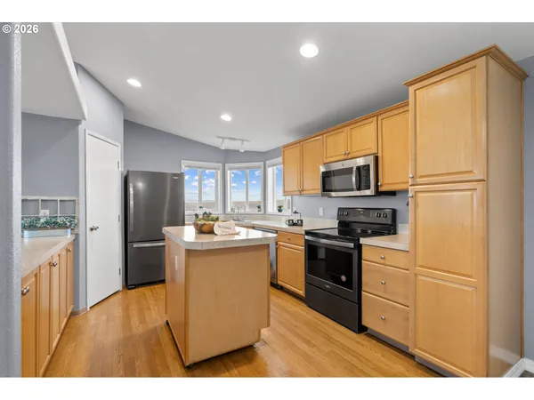 a kitchen with refrigerator and microwave