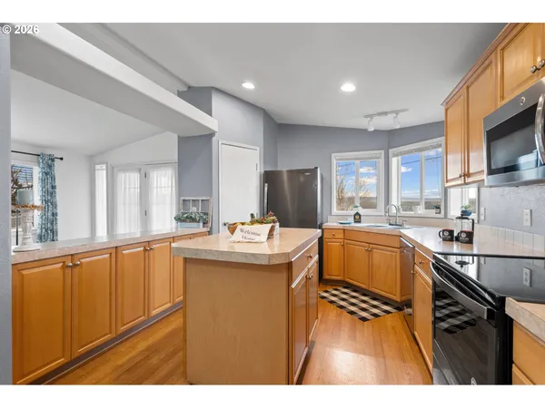 a kitchen with counter top space a sink and appliances