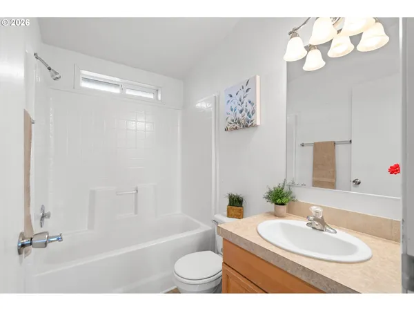 a bedroom with a bed next to a window