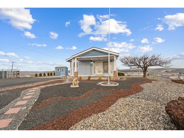 a living room with patio furniture and a floor to ceiling window